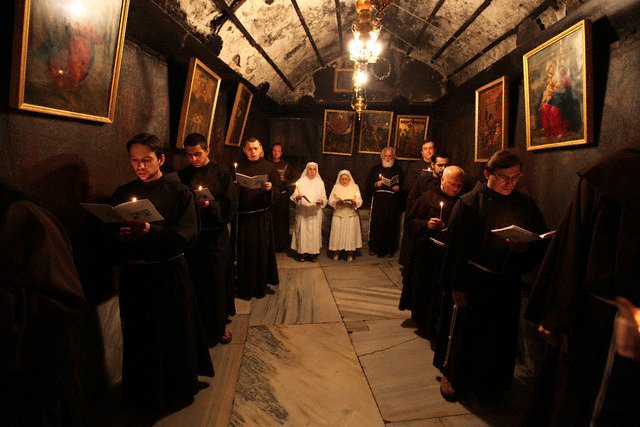 23 Dec 2009, BETHLEHEM, West Bank , ... --- epa01973786 Franciscan monks in the Grotto during prayers at the Church of the Nativity in the biblical West Bank city of Bethlehem on 23 December 2009. Christian pilgrims are preparing to gather in the traditional birthplace of Jesus Christ in the West Bank to celebrate Christmas. EPA/ABED AL HASHLAMOUN --- Image by © ABED AL HASHLAMOUN/epa/Corbis